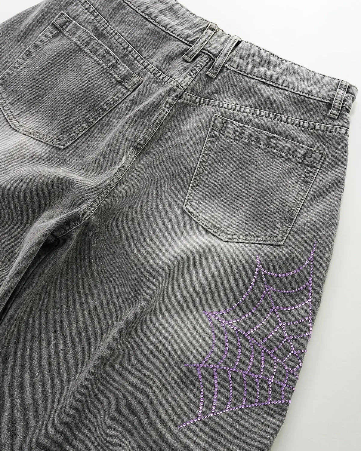 Inflation Spider Graphic Rhinestone Barrel Jeans displaying a bold spider graphic and rhinestone embellishments on stylish denim pants.