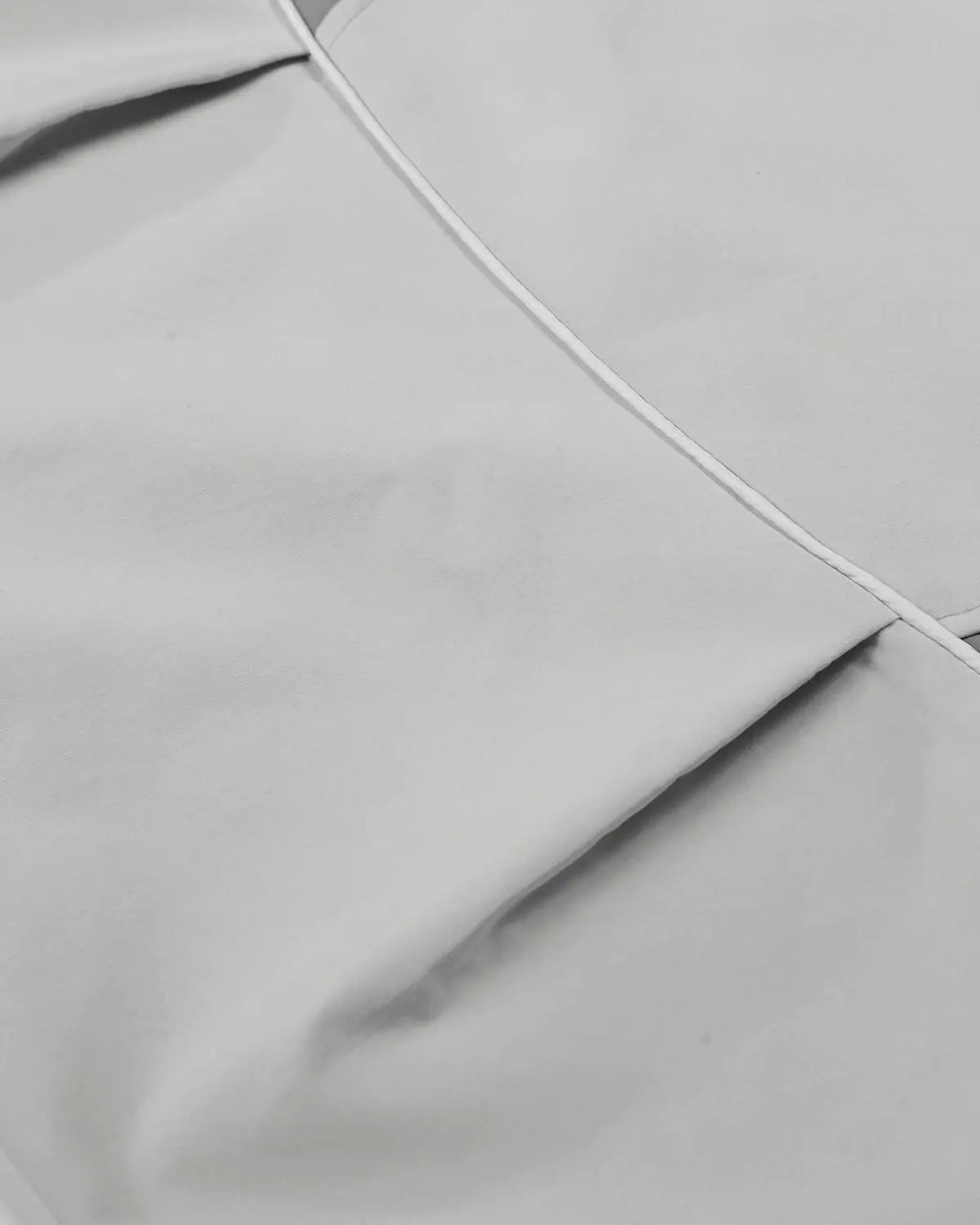 Inflation Streetwear contrast panel baggy track pants with black and white color blocks, relaxed fit, and logo detailing.