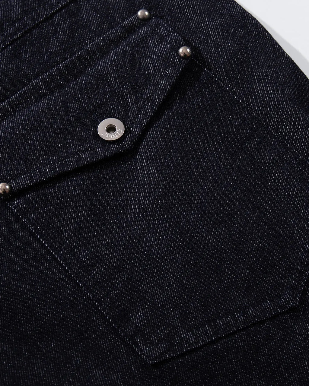 Inflation Buttons Up Raw Blue Baggy Jeans showing relaxed fit, distressed denim, and button fly details on light blue denim fabric.