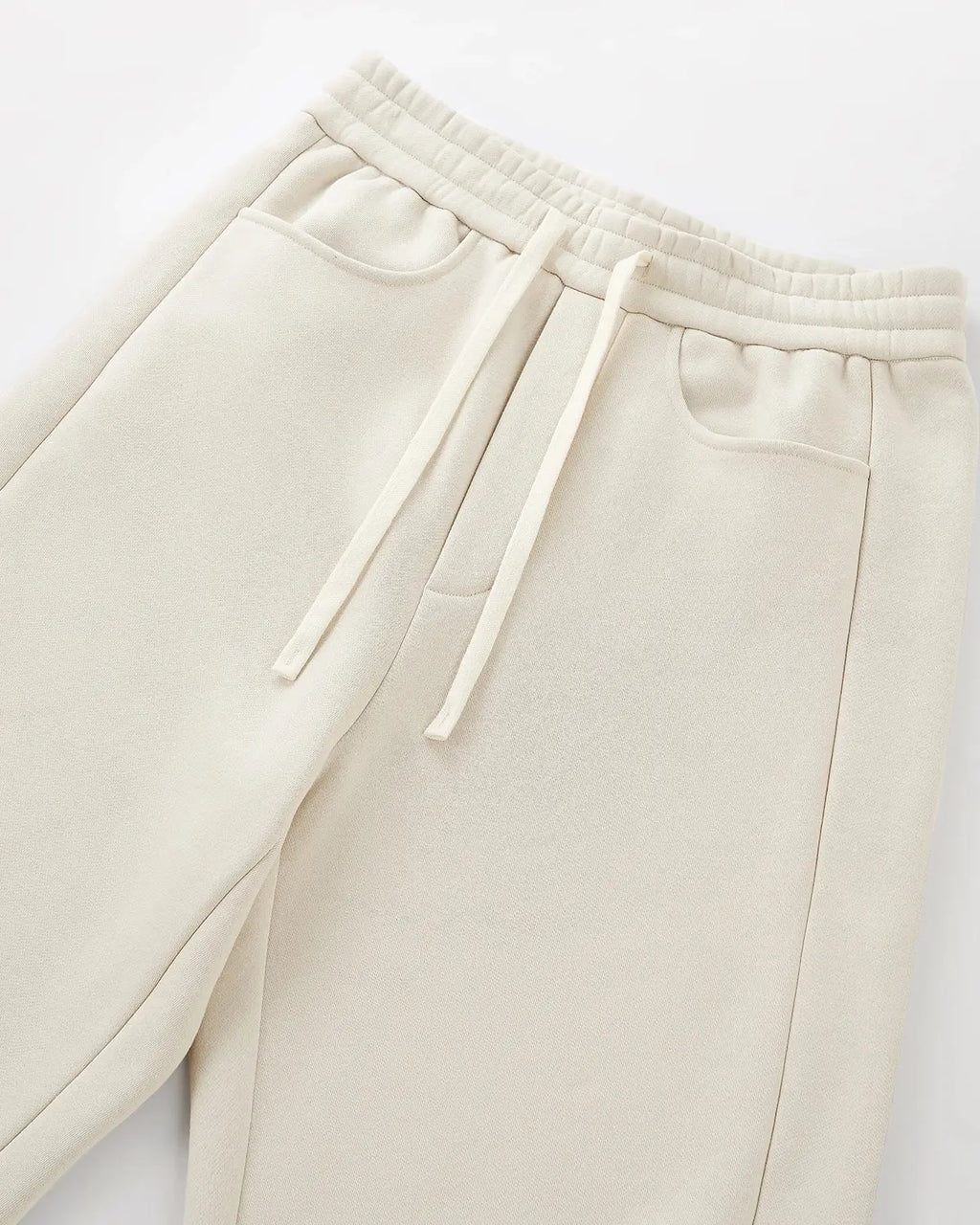 Inflation Streetwear solid color fleece barrel sweatpants with elastic waistband and relaxed fit, shown in a neutral color.