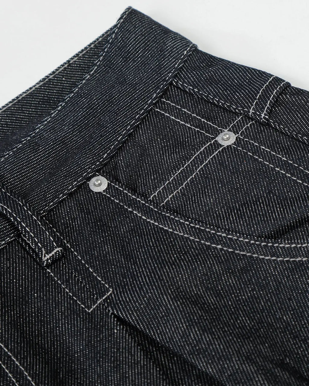 Raw baggy jeans with contrast stitching from Inflation Streetwear, featuring a relaxed fit and distressed denim style.