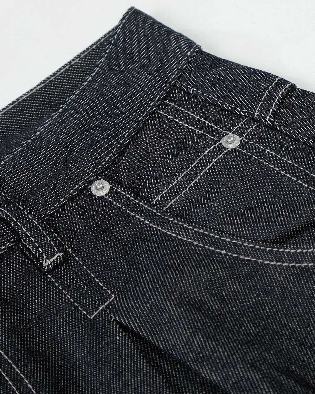 Raw baggy jeans with contrast stitching from Inflation Streetwear, featuring a relaxed fit and distressed denim style.