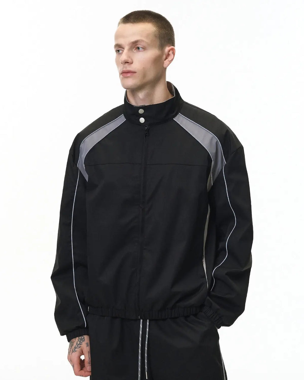 Reflective windbreaker track jacket by INFLATION with streetwear style, featuring reflective accents and lightweight design.