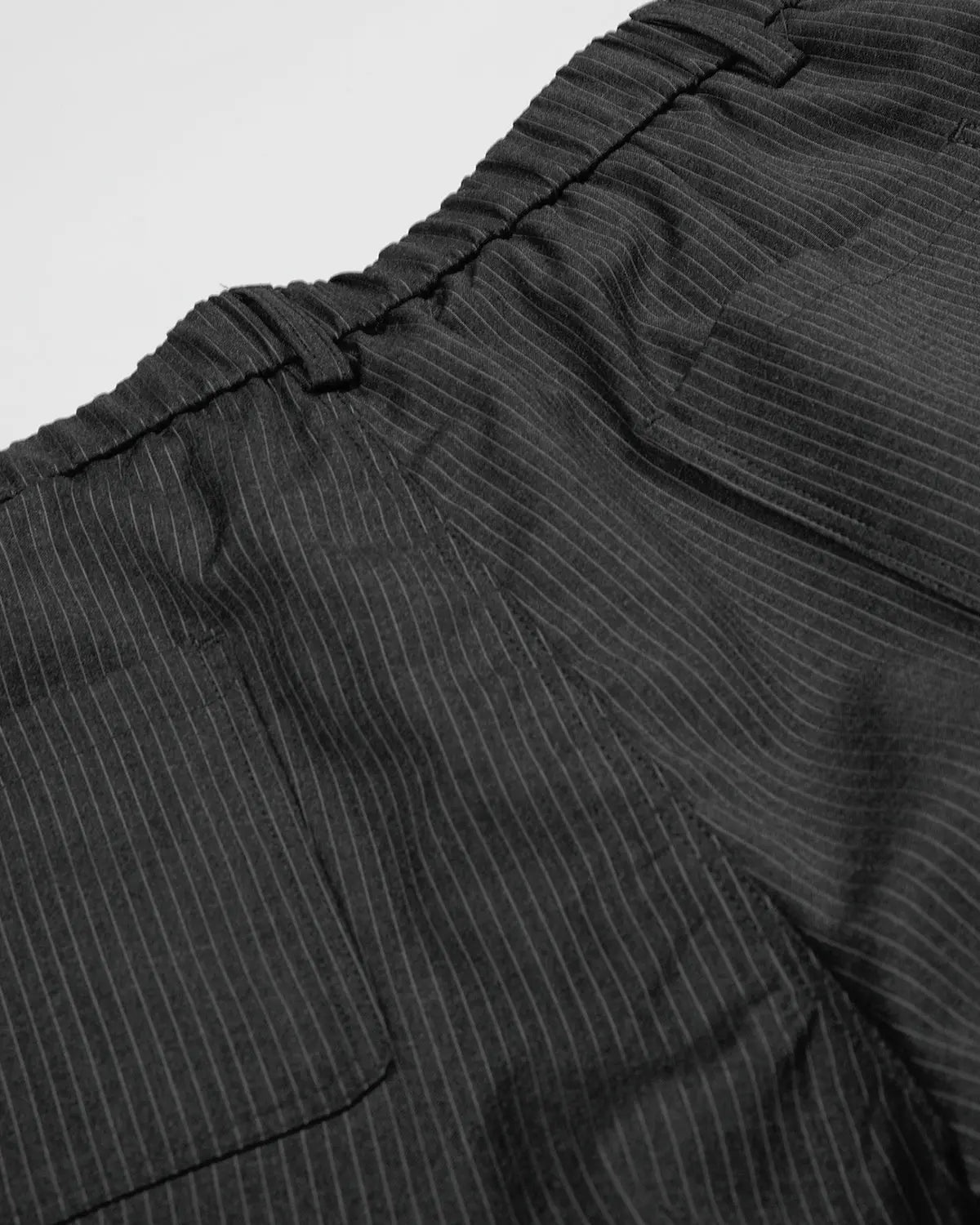 Inflation Streetwear pinstripe stud detail tailored shorts, stylish pants with pinstripe pattern and metal stud accents.