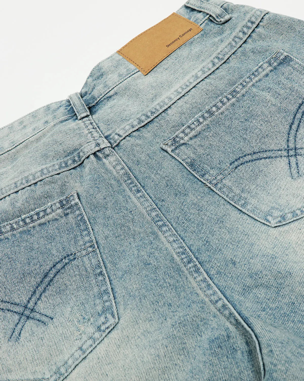 Distressed longline jorts by INFLATION, denim shorts with frayed edges and a relaxed fit, styled for streetwear fashion.