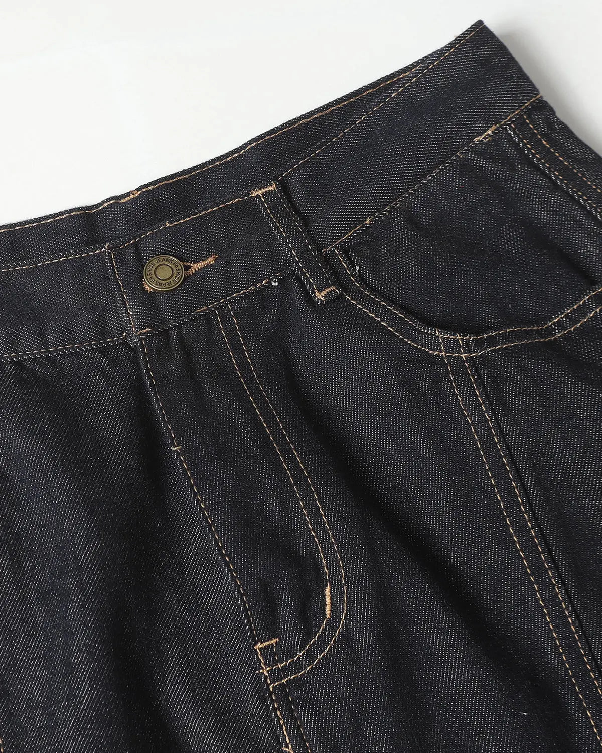 Deconstructed scimitar denim longline jorts by INFLATION, showcasing distressed, oversized design with raw hem and unique cutouts.