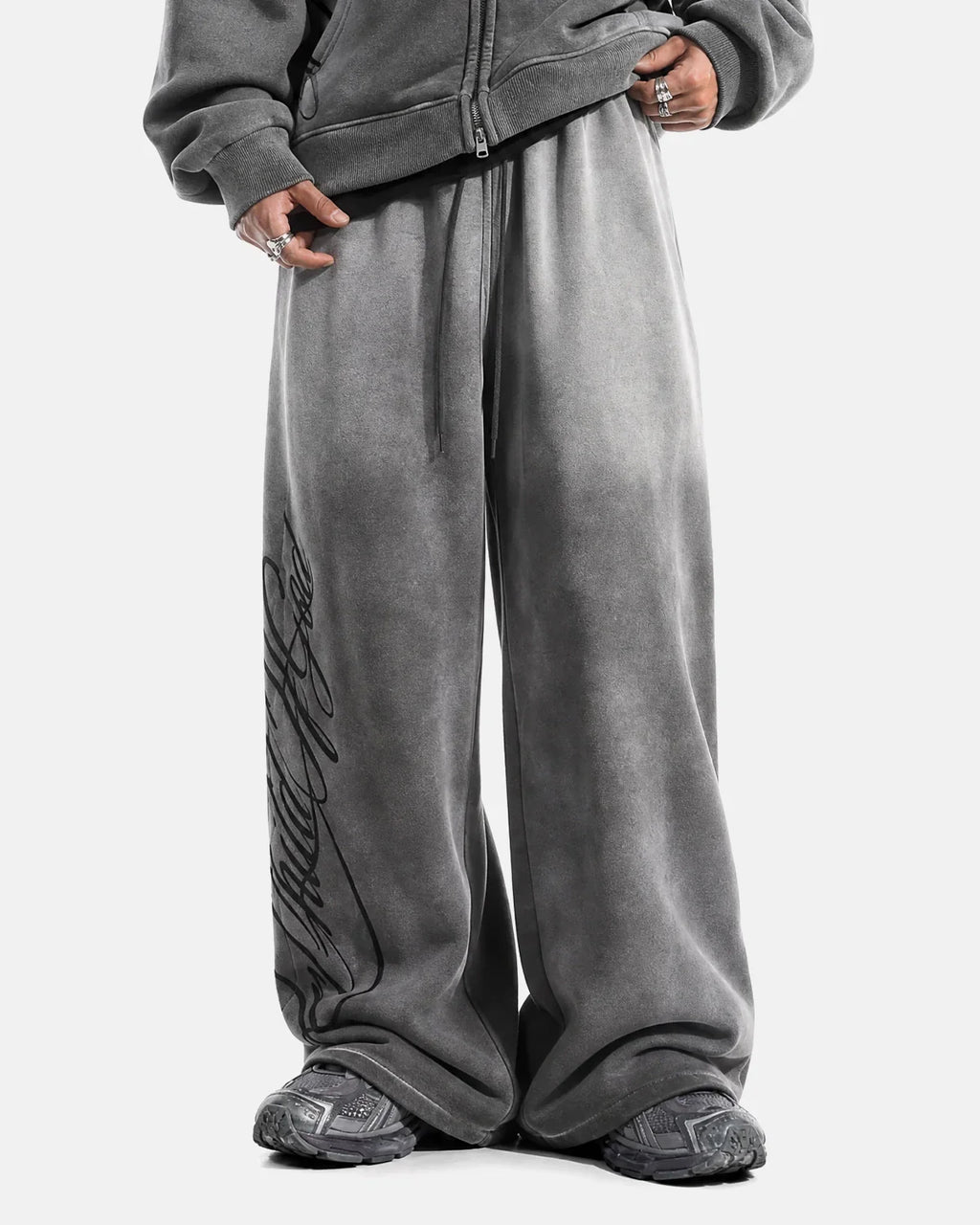 Acid washed black sweatpants by INFLATION, streetwear style with relaxed fit and distressed finish, casual and trendy clothing.