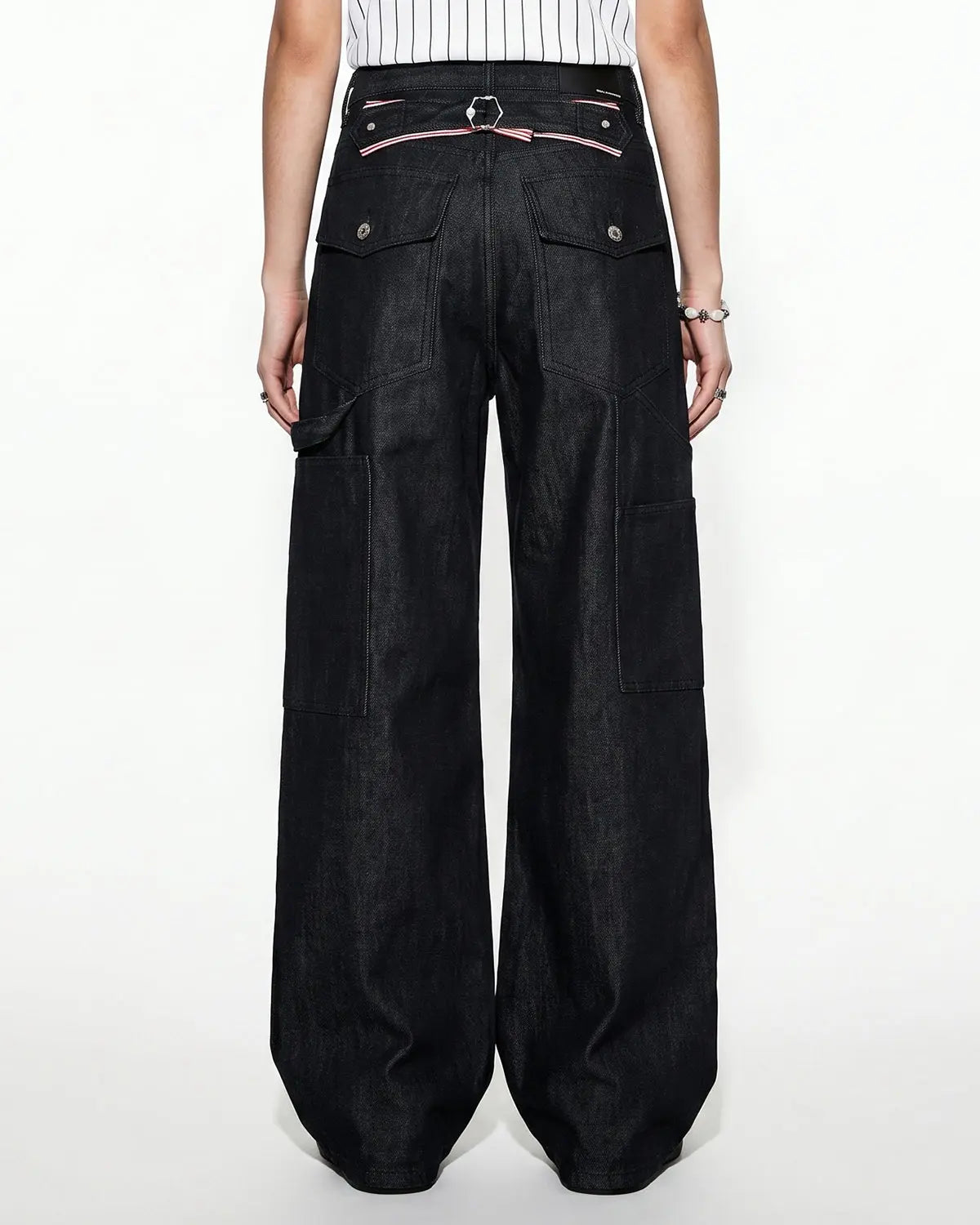 Deconstructed utility baggy jeans by INFLATION featuring oversized fit, multiple pockets, and distressed denim details.