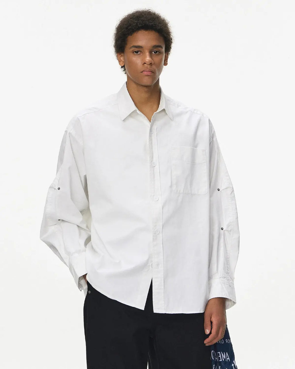 Acid wash cargo shirt jacket by INFLATION, streetwear style with multiple pockets and a relaxed fit, displayed on a hanger.