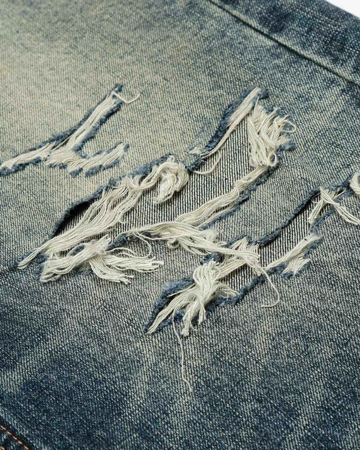 Vintage distressed baggy jeans from Inflation Streetwear, featuring a relaxed fit and worn-in denim style.
