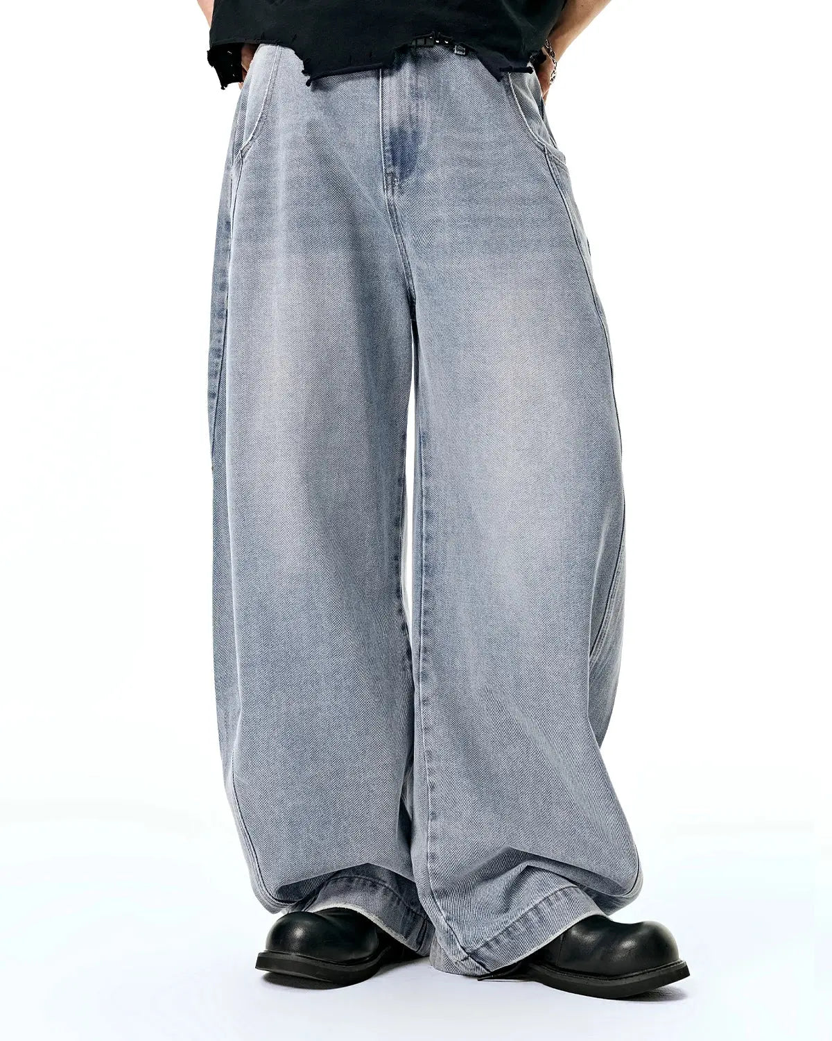 Acid washed distressed barrel jeans by INFLATION, showcasing faded denim, ripped details, and relaxed fit style.