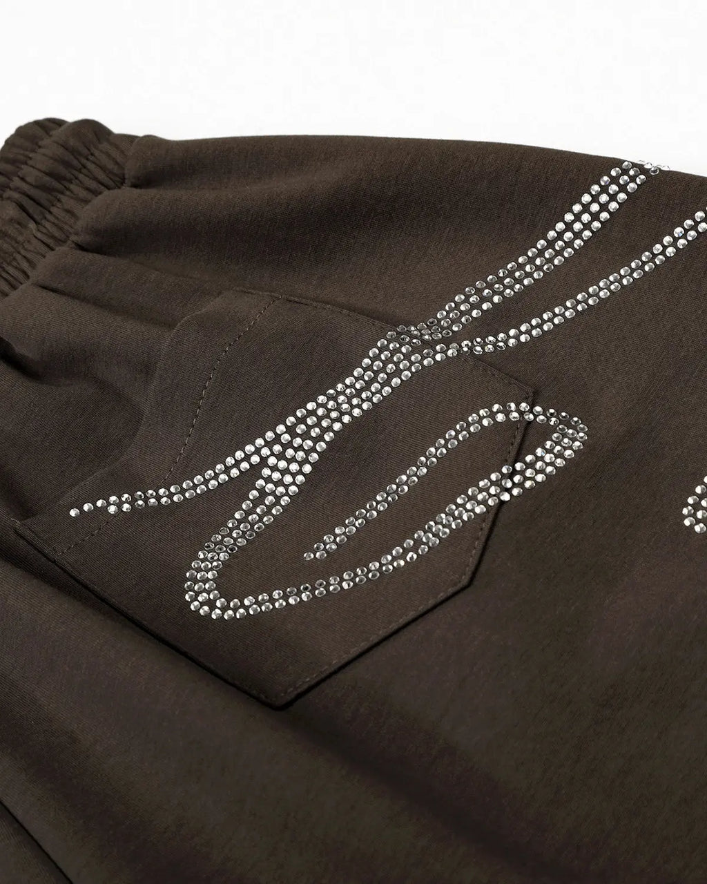 Rhinestone baggy joggers from INFLATION Streetwear with sparkling rhinestone accents and relaxed fit, shown in a close-up view.