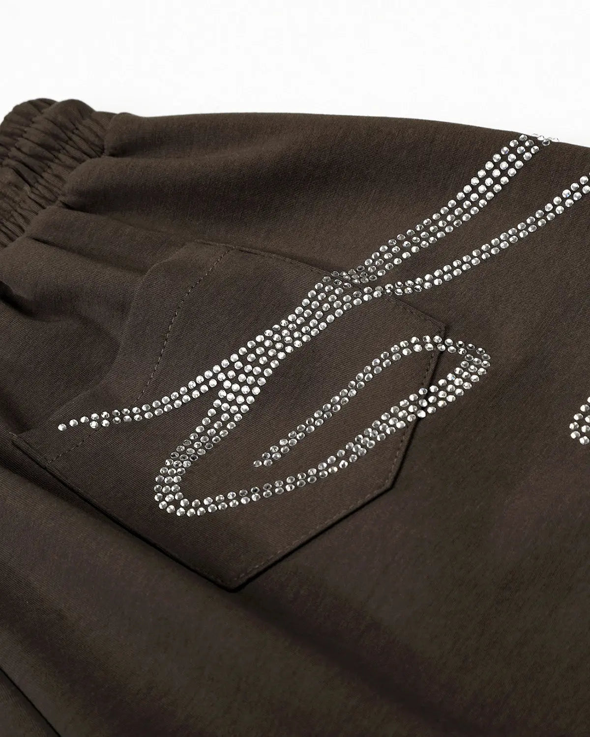 Rhinestone baggy joggers from INFLATION Streetwear with sparkling rhinestone accents and relaxed fit, shown in a close-up view.