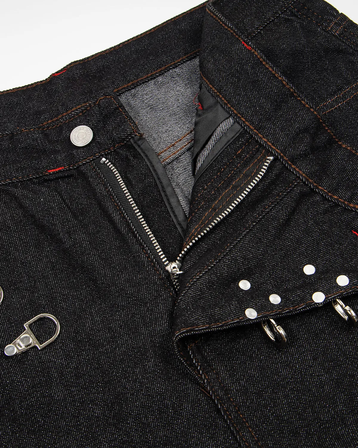 Raw baggy jeans with asymmetric buckle details from INFLATION, featuring a relaxed fit and streetwear style.