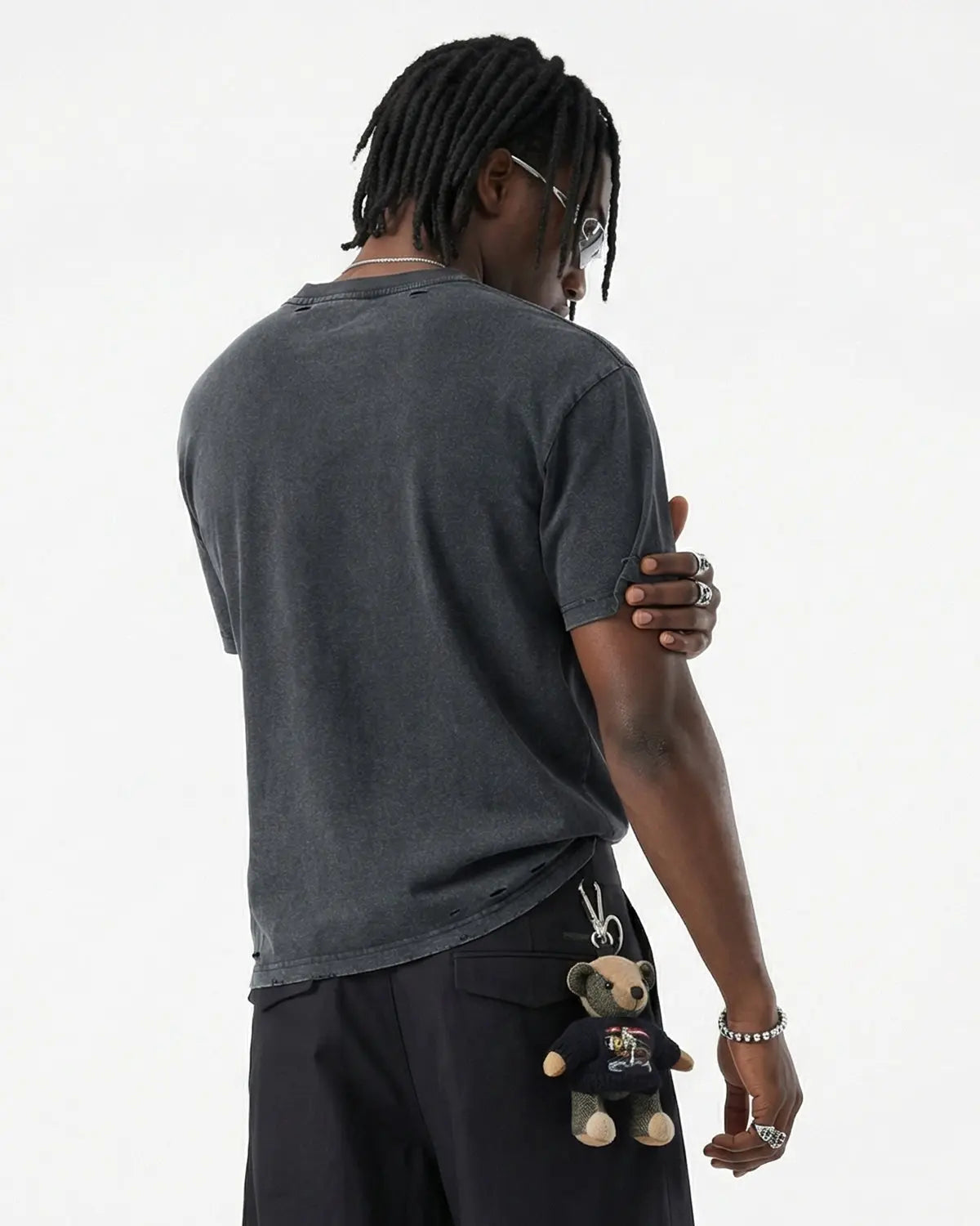 Oversized distressed washed T-shirt by INFLATION with ripped details, casual streetwear style, shown on a hanger.