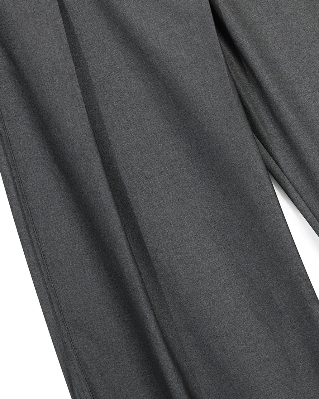 Asymmetric pleated barrel-leg suit pants by INFLATION, featuring stylish design and tailored fit in neutral fabric.