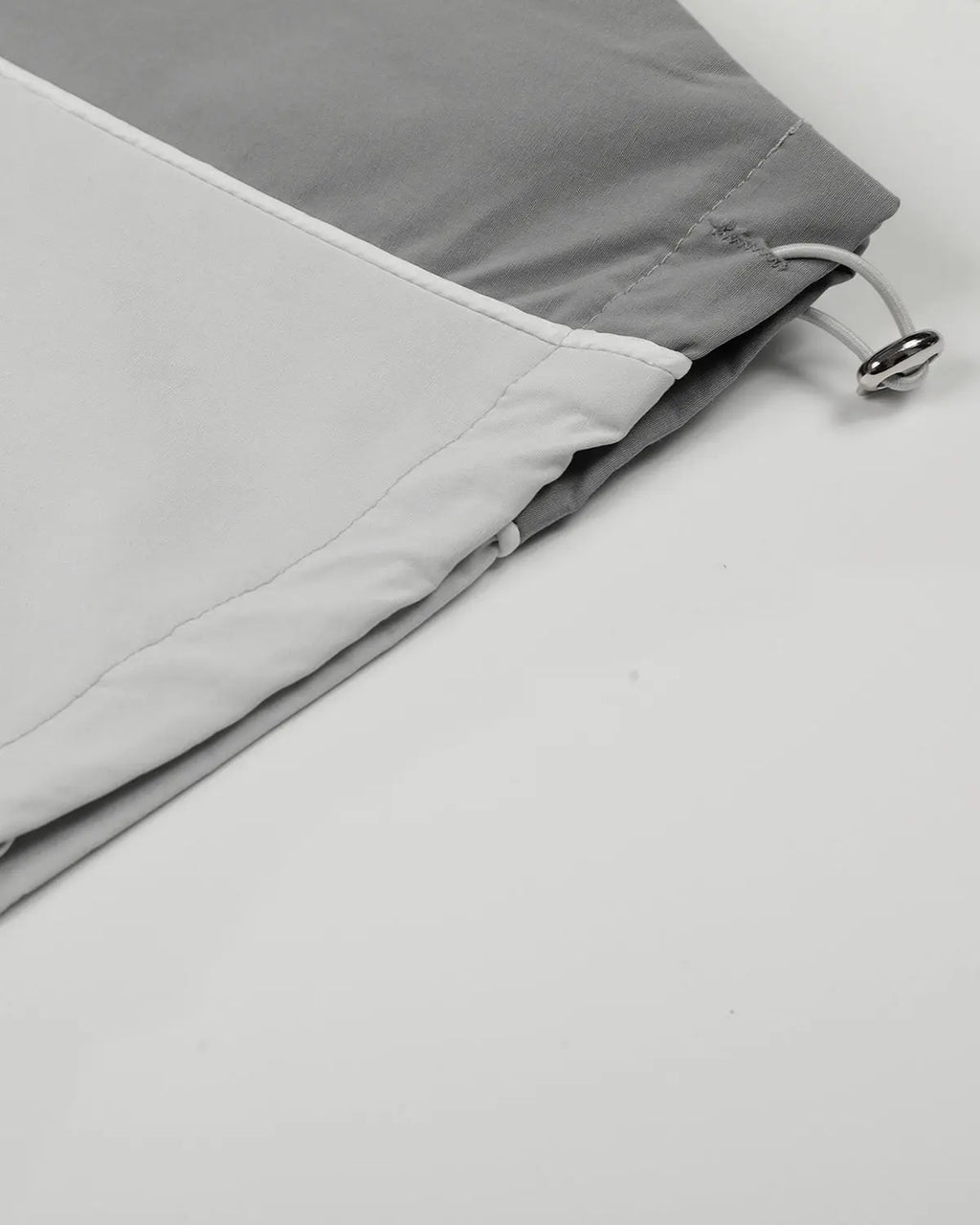 Inflation Contrast Panel Baggy Track Pants featuring black and white color blocks and a loose, comfortable fit for streetwear style.