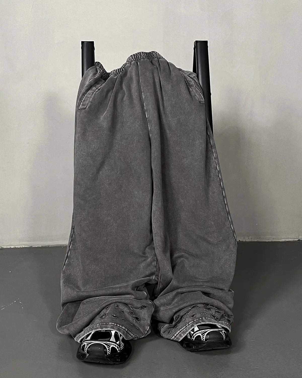 Inflation streetwear ripped acid wash sweatpants with distressed detailing and relaxed fit, shown in a casual streetwear style.