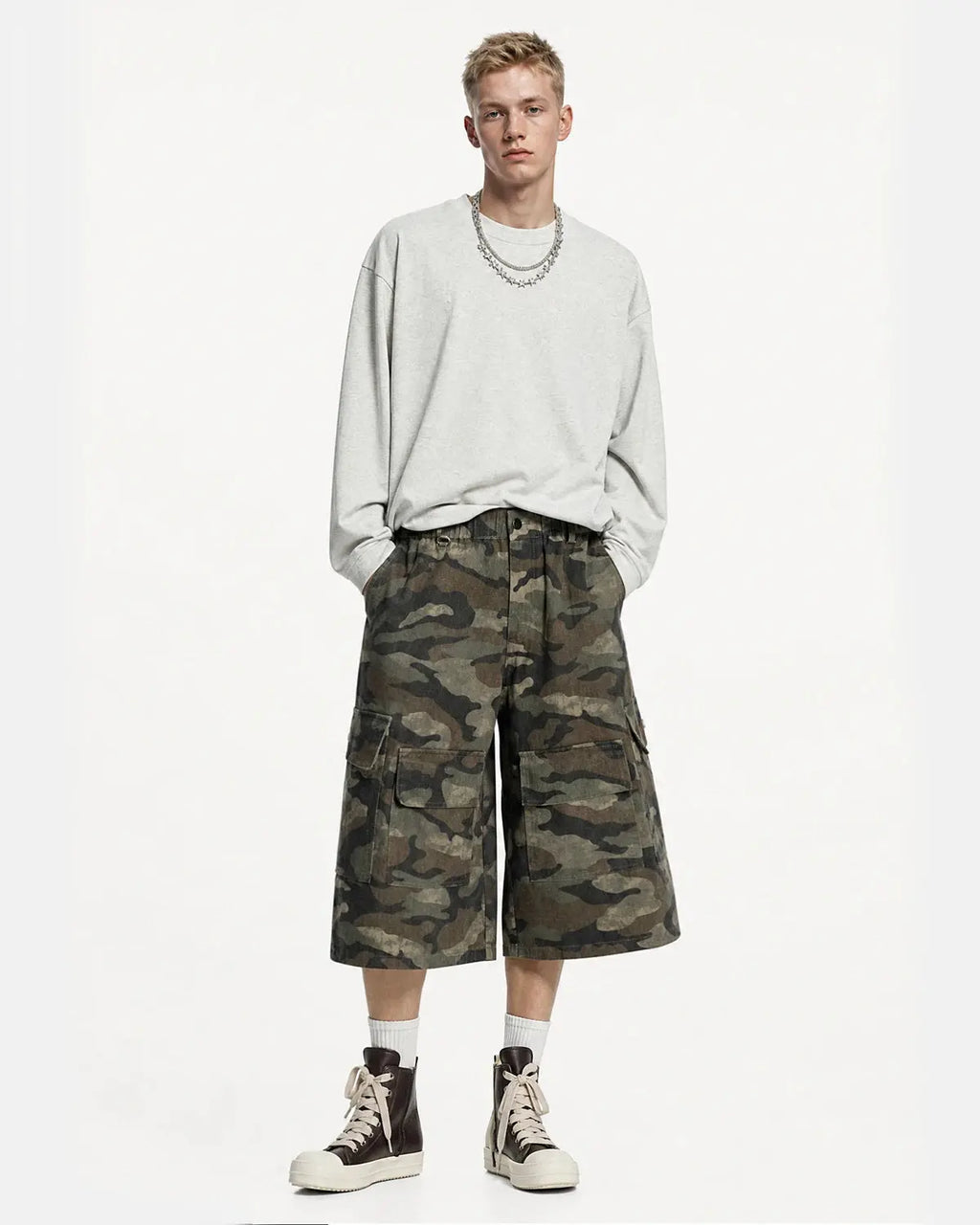 Grey camo utility longline shorts by INFLATION, featuring multiple pockets and a relaxed fit, styled for streetwear casual.