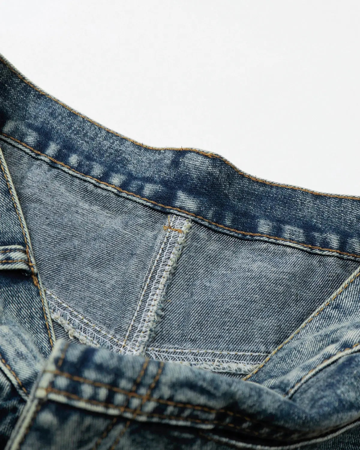 Inflation brand studded washed long baggy jorts, denim pants with metal stud accents, relaxed fit and distressed wash style.