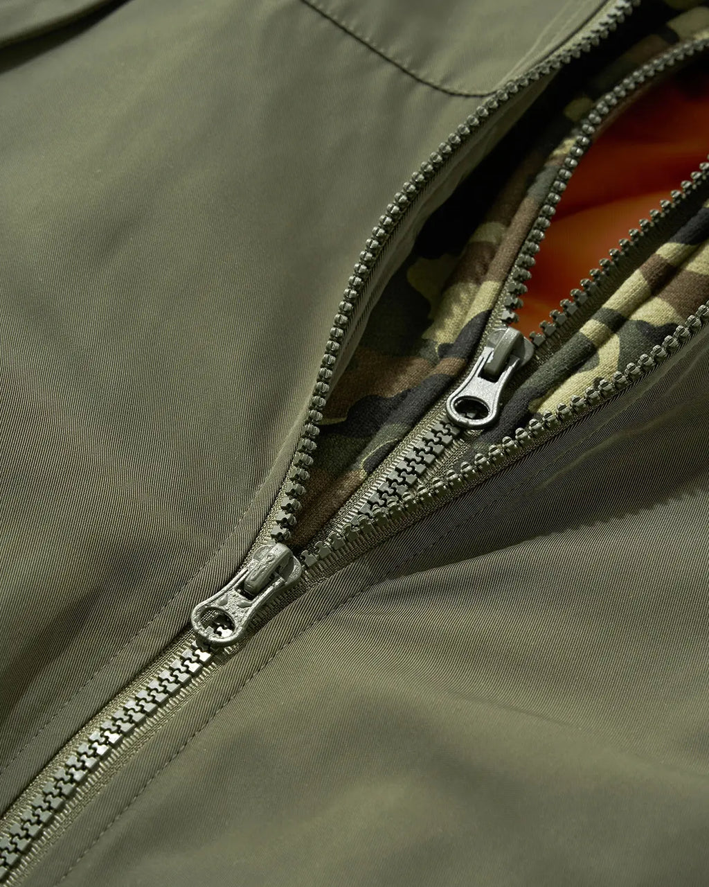 Detachable layered camo bomber jacket by INFLATION featuring a streetwear-inspired design with layered camouflage details.
