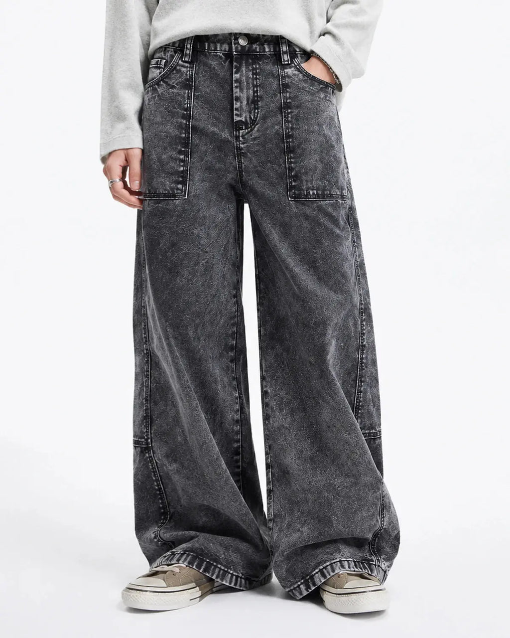 Deconstructed distressed barrel jeans by INFLATION featuring ripped details and a relaxed streetwear style, shown from the front.