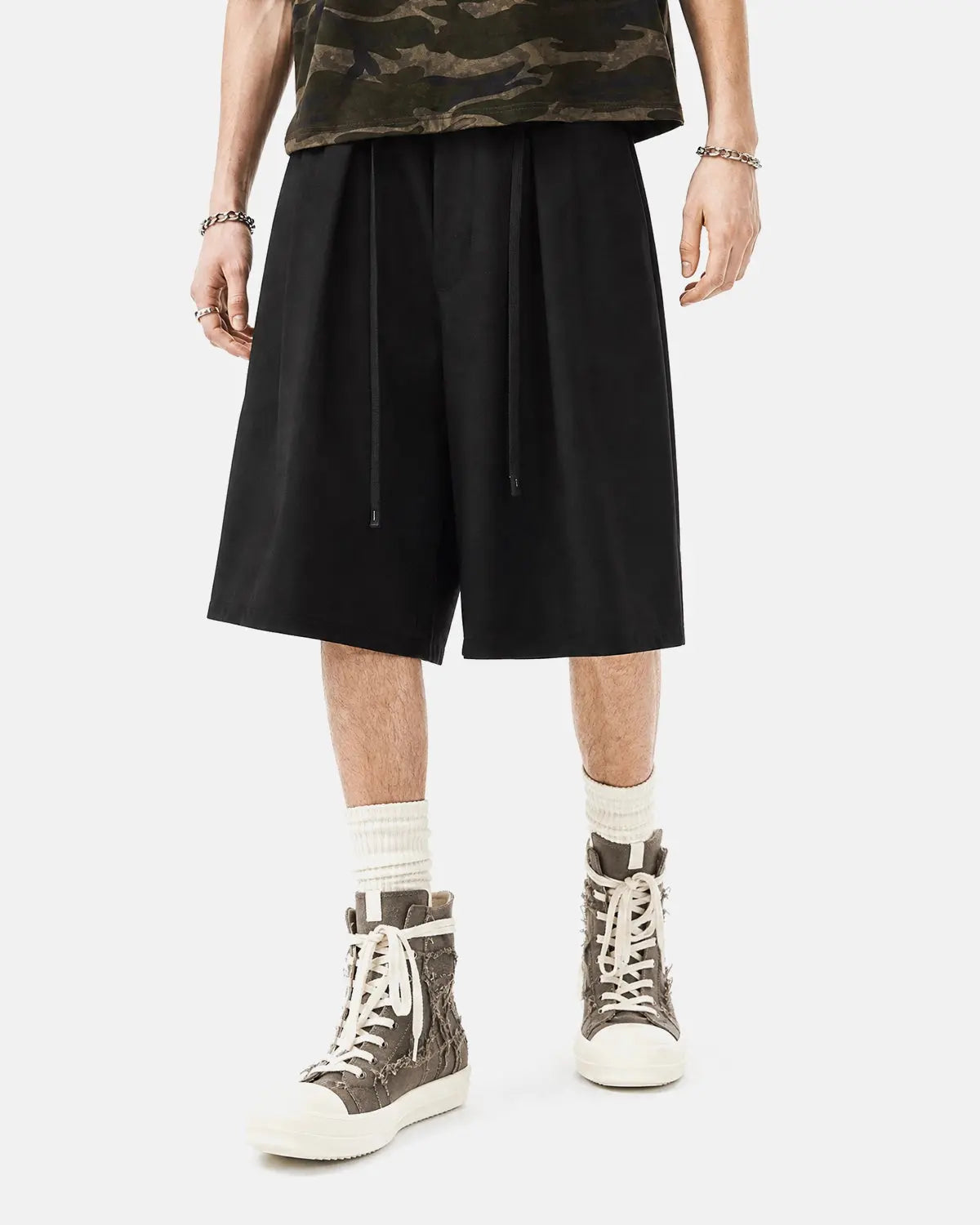 Inflation Streetwear drawstring wide-leg tailored shorts in black, featuring a relaxed fit and adjustable waistband.