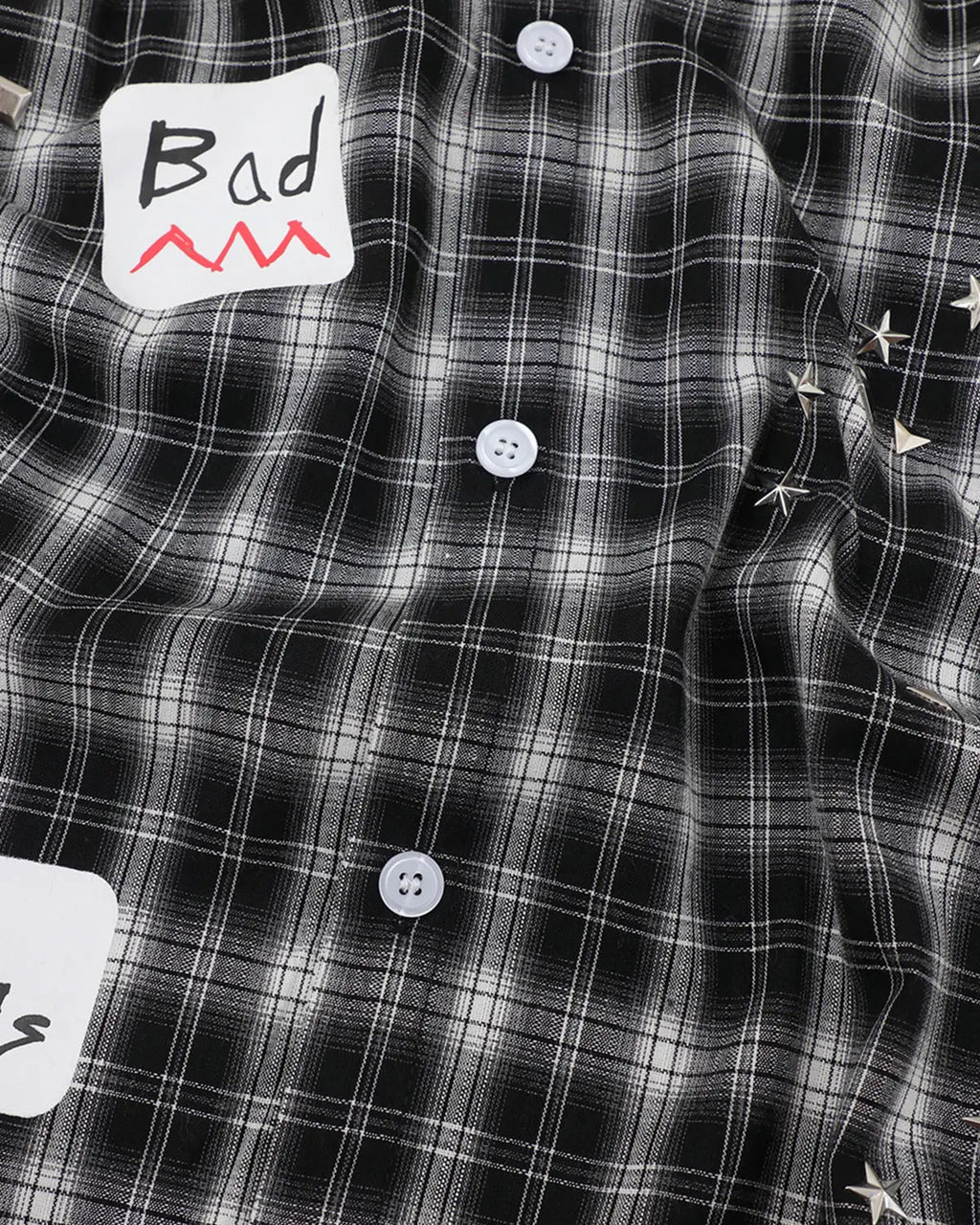 Inflation Streetwear plaid sticker graphic studded shirt featuring a checkered pattern, casual fit, and metal stud accents.
