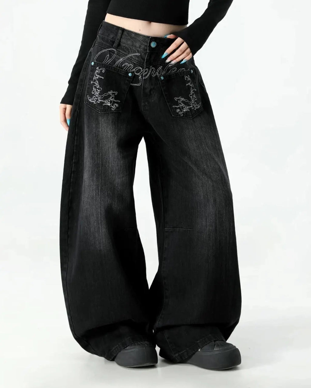 Graphic embroidered washed barrel jeans by INFLATION, showing distressed denim with colorful embroidery and a relaxed fit.