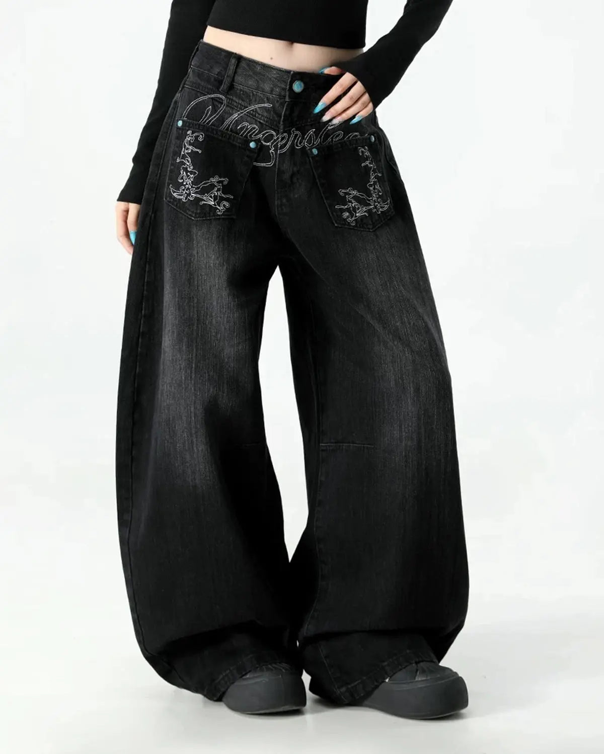 Graphic embroidered washed barrel jeans by INFLATION, showing distressed denim with colorful embroidery and a relaxed fit.