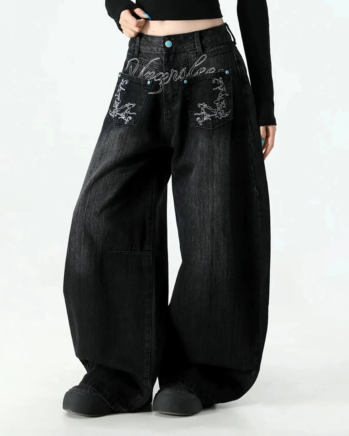 Graphic embroidered washed barrel jeans by INFLATION, styled as casual streetwear pants with distressed denim and unique embroidered details.