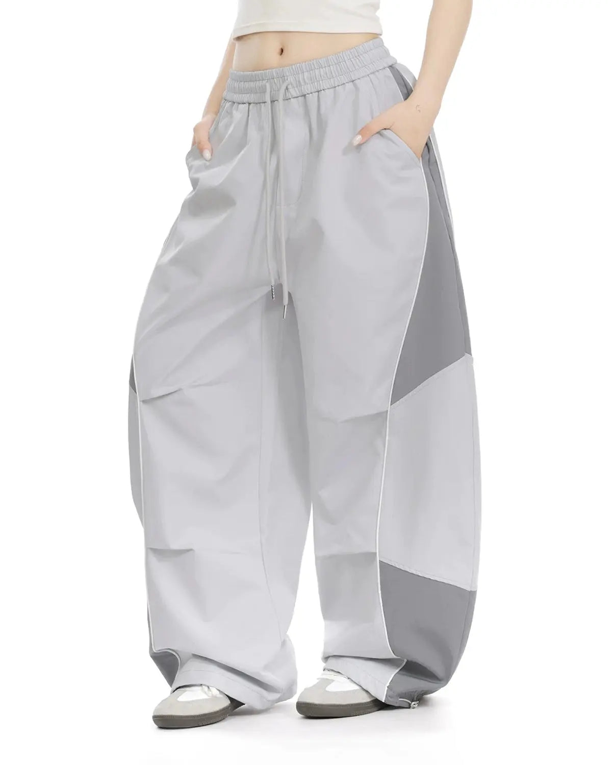 Inflation Streetwear contrast panel baggy track pants with bold color blocks and relaxed fit, shown on a model.