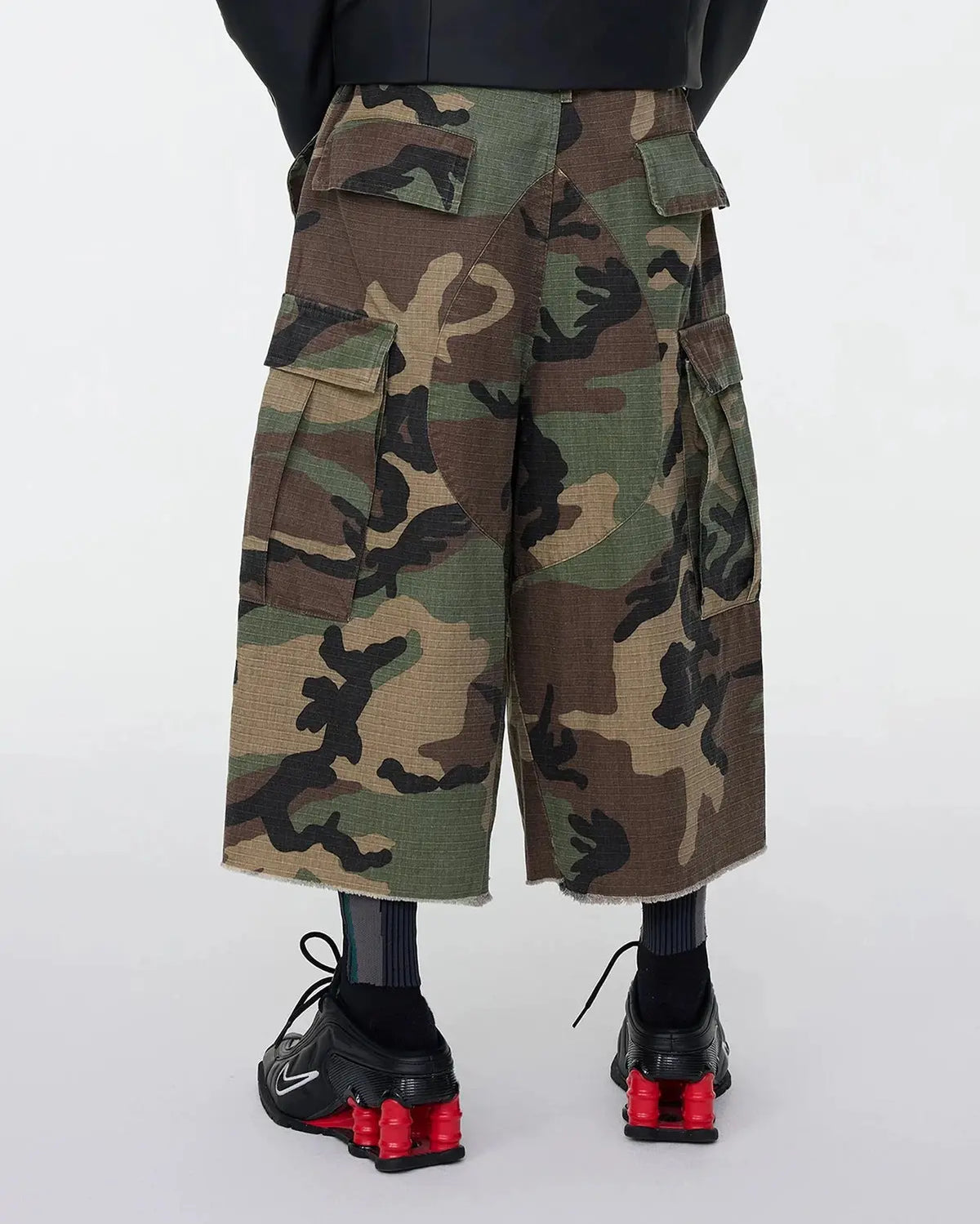 Inflation Streetwear oversized camo cargo longline shorts with multiple pockets and relaxed fit, featuring a bold camouflage pattern.