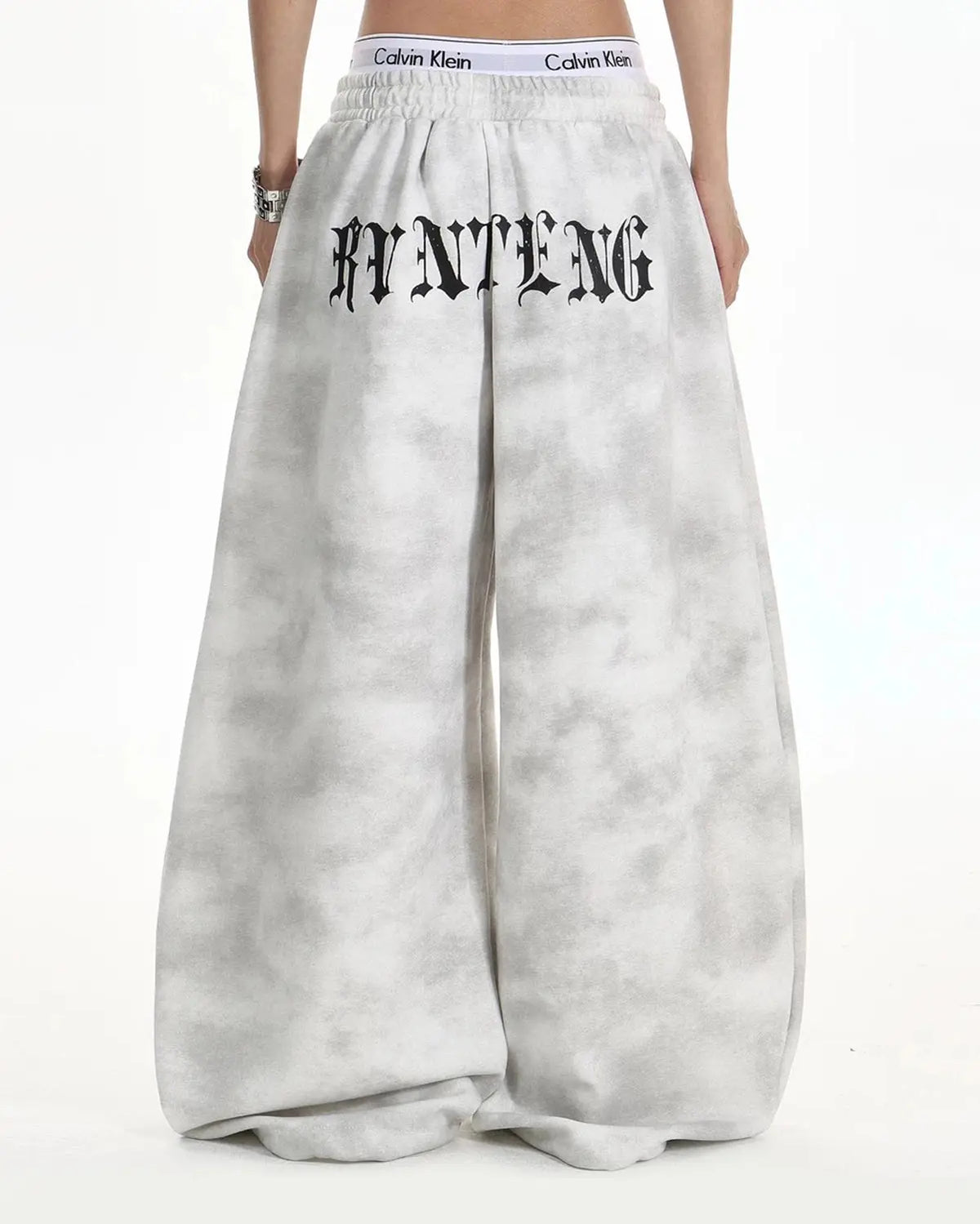 Washed black cross barrel sweatpants by INFLATION, featuring a relaxed fit and stylish streetwear design with brand logo detail.