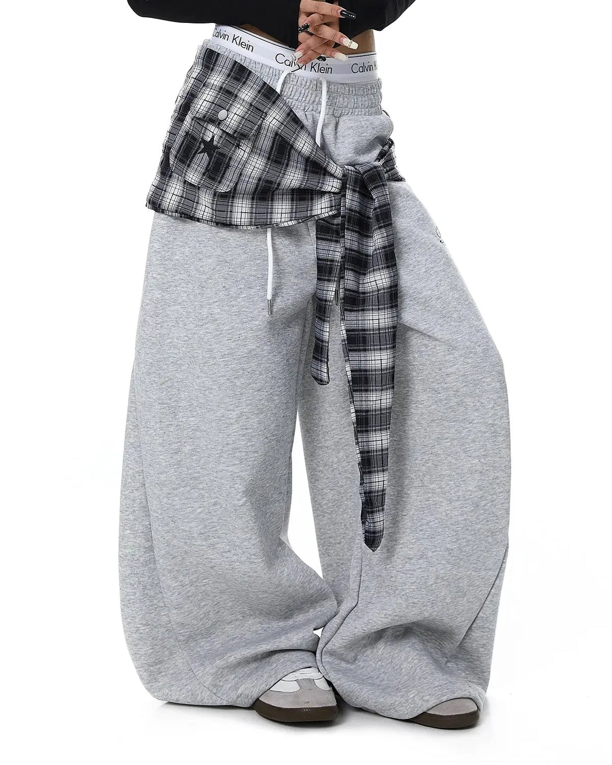 Plaid layered baggy sweatpants by INFLATION, featuring a relaxed fit and layered design with plaid pattern, casual streetwear style