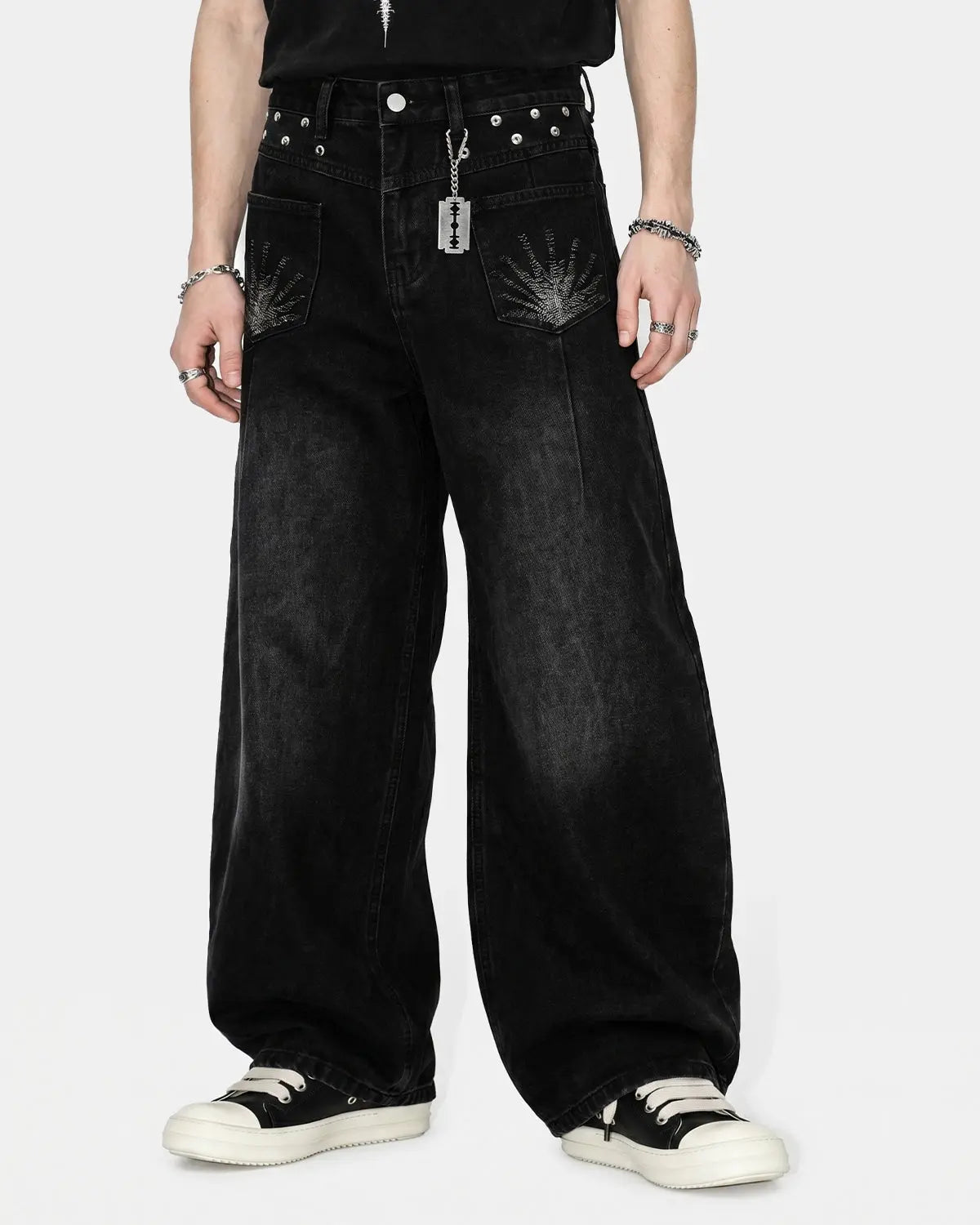 Distressed eyelet barrel jeans by INFLATION featuring ripped details, eyelet accents, and a relaxed fit style.