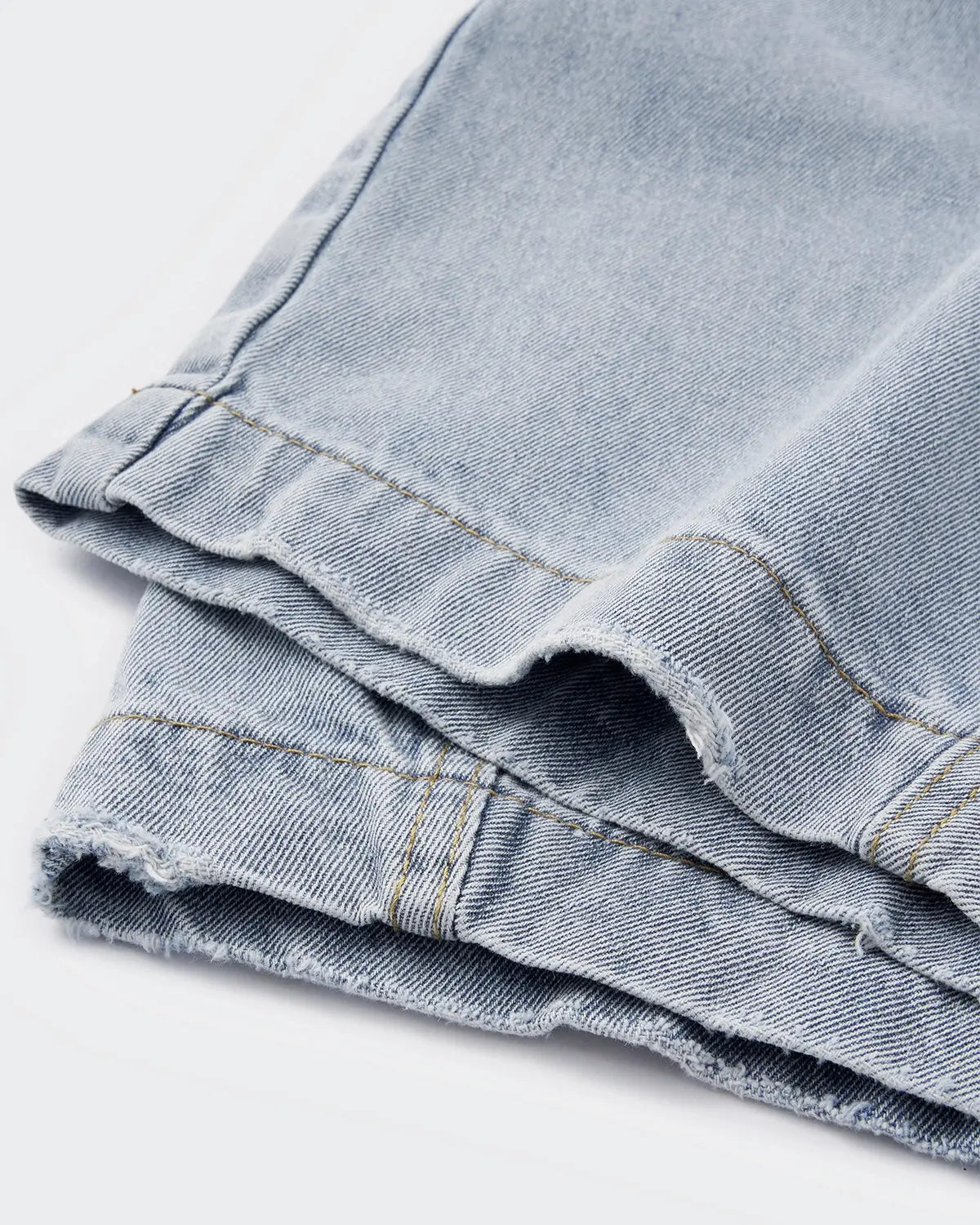 Acid washed distressed barrel jeans by INFLATION, casual pants with ripped details and a relaxed fit, displayed on a model.