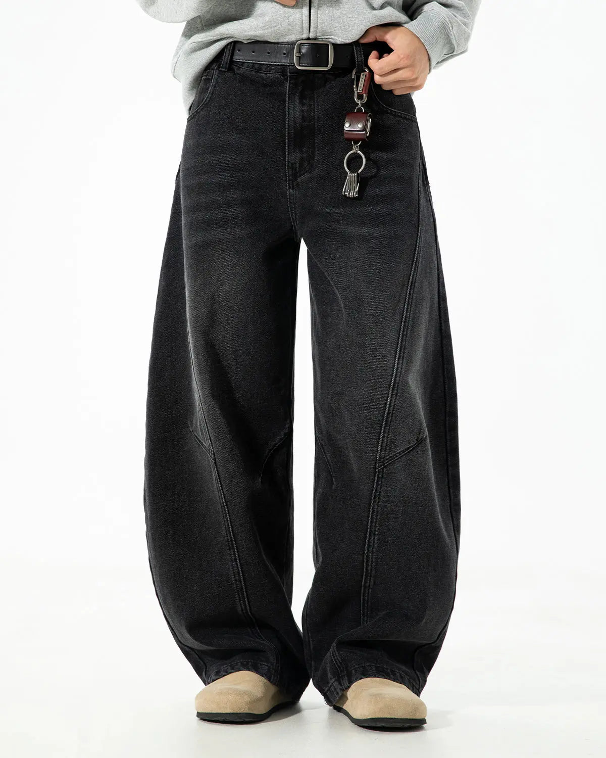 Curved seam deconstructed barrel jeans by INFLATION featuring unique stitching and distressed denim, stylish streetwear look.