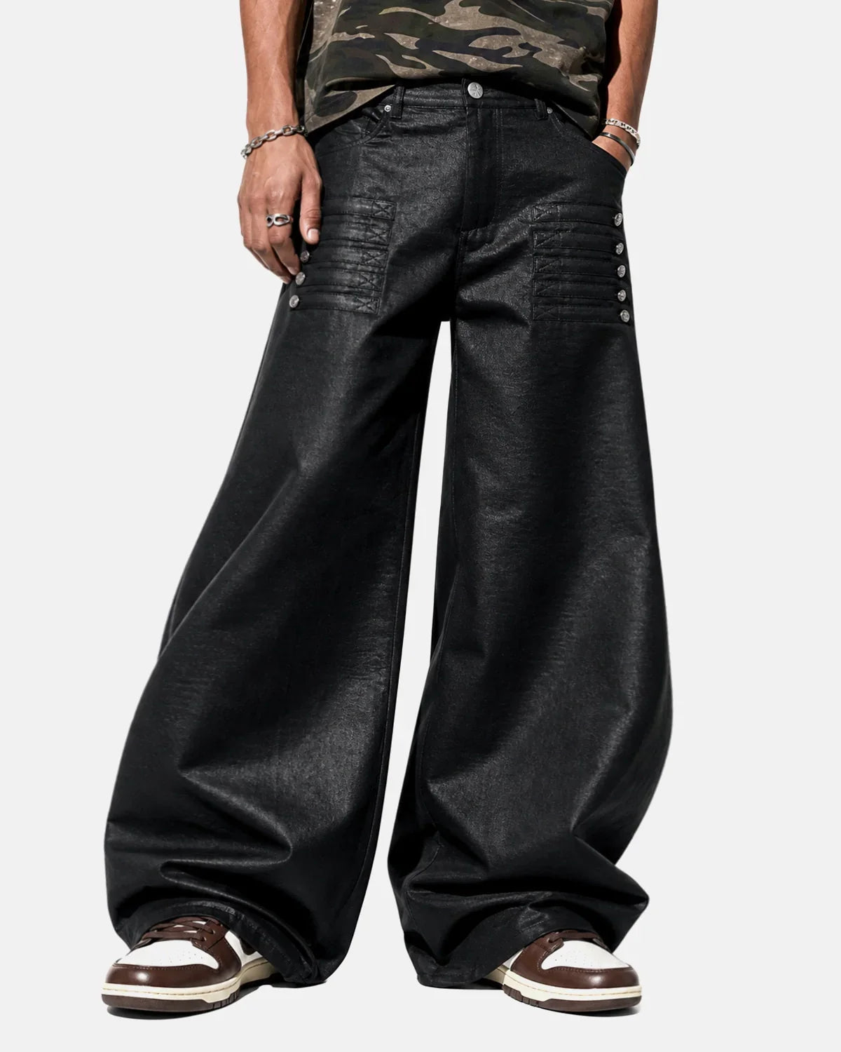 Black graphic wide-leg pants by INFLATION featuring bold designs and relaxed fit, styled with a streetwear aesthetic.