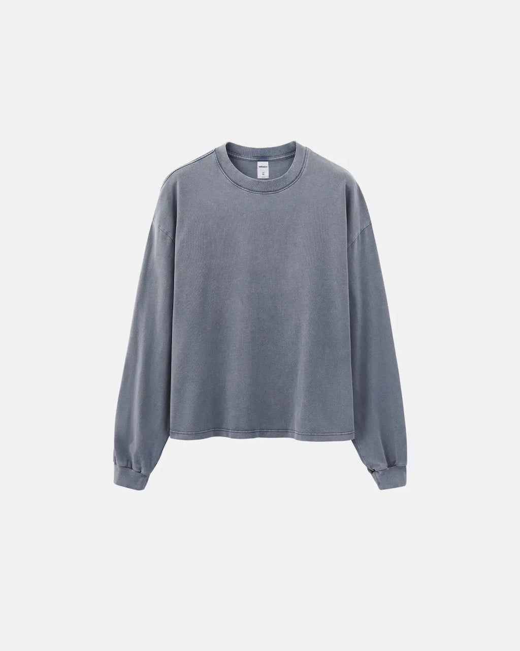 Distressed washed long sleeve tee by INFLATION, featuring a relaxed fit, faded fabric, and casual streetwear style.