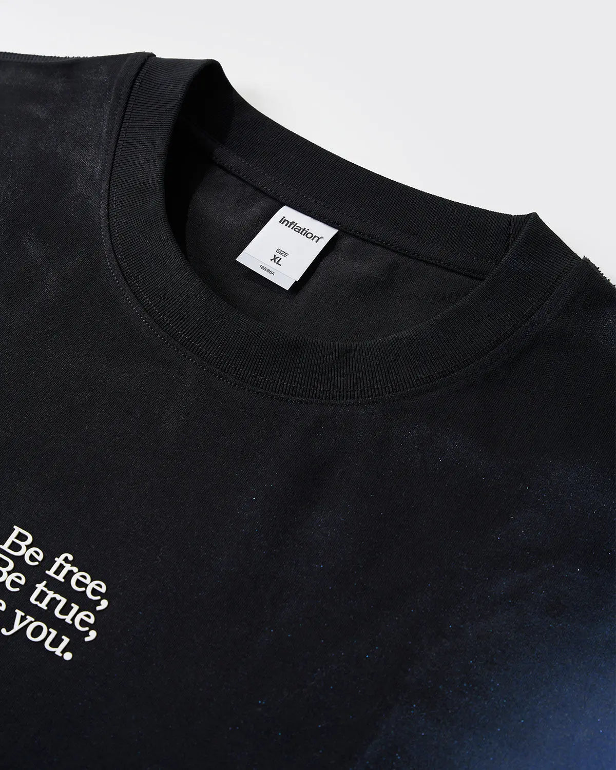 Iridescent shimmer oversized T-shirt by INFLATION featuring a reflective, metallic fabric with a relaxed fit and streetwear style.