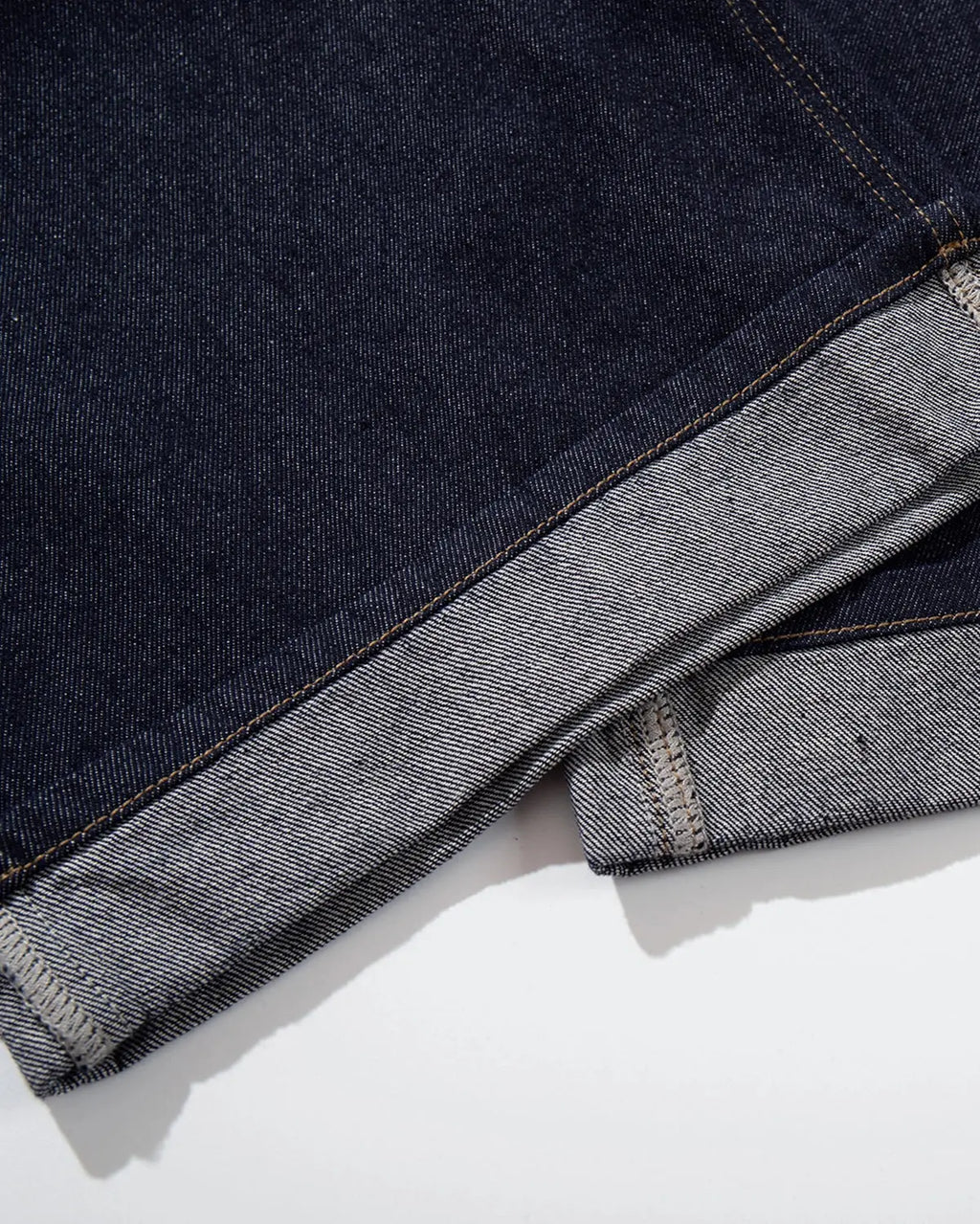 Inflation brand cinch back baggy denim jorts pants with distressed details, relaxed fit, and high-rise waist on a model.