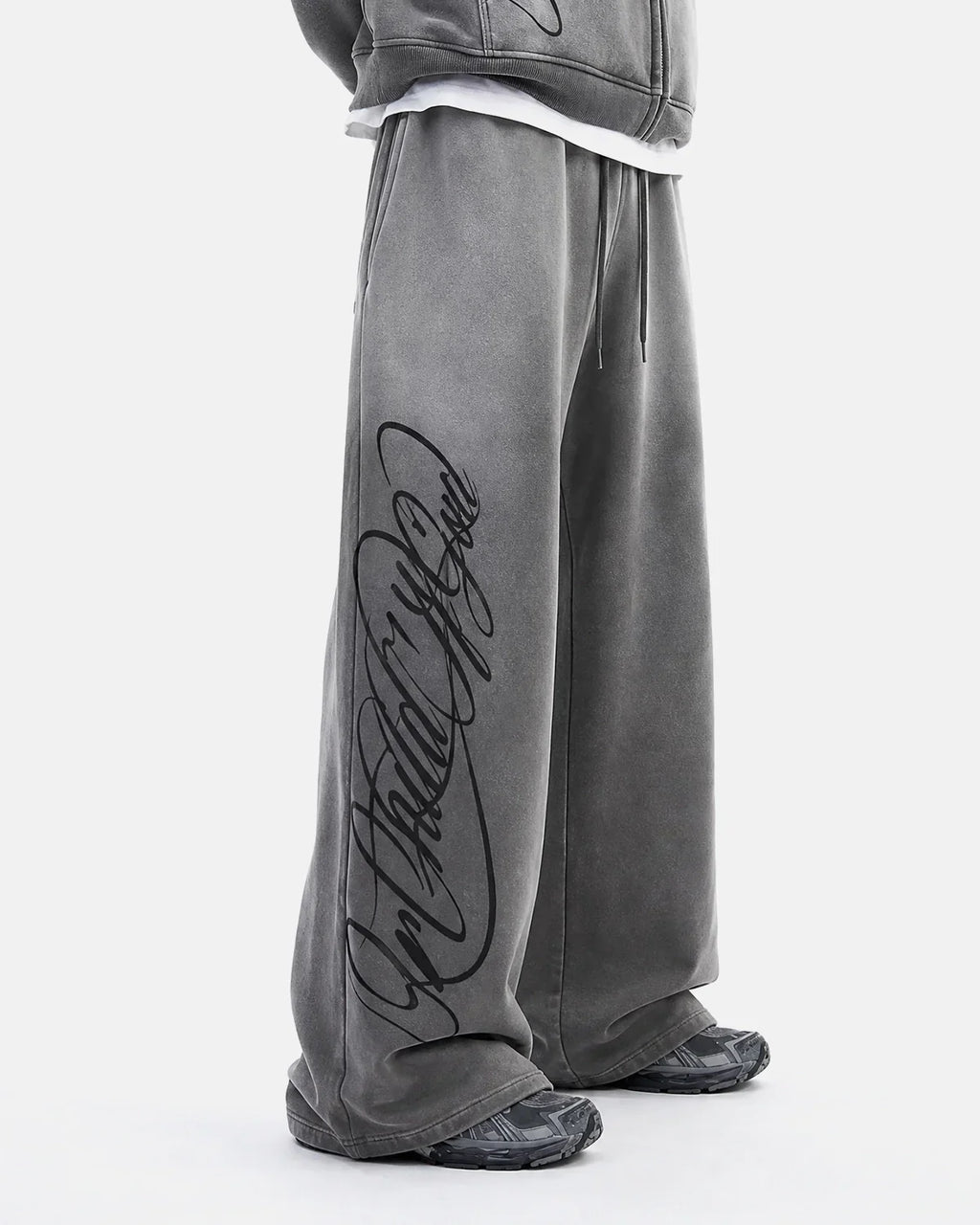 Acid washed INFLATION sweatpants with relaxed fit, showcasing soft fabric and distressed detailing on a neutral background.