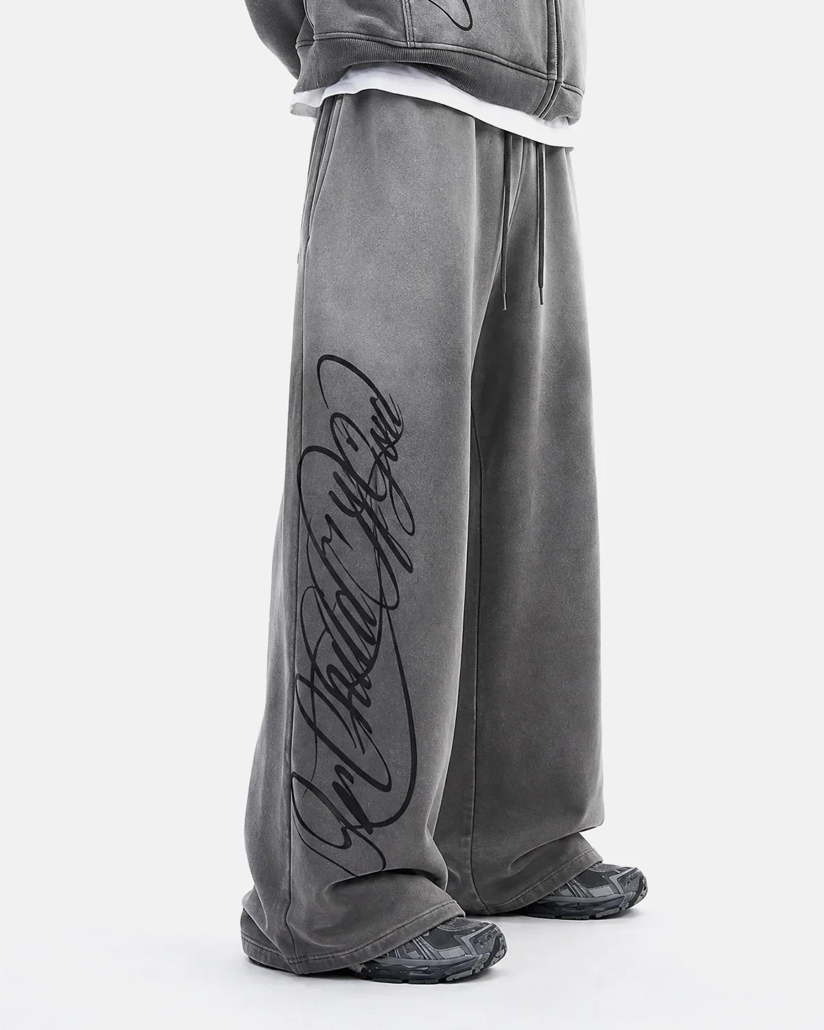 Acid washed INFLATION sweatpants with relaxed fit, showcasing soft fabric and distressed detailing on a neutral background.