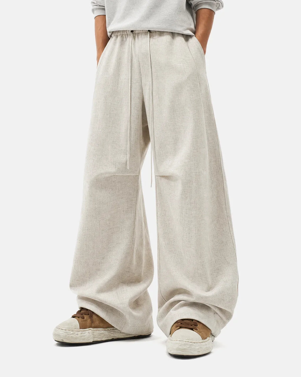 Light beige cotton linen wide-leg pants from INFLATION streetwear, shown laid flat with focus on relaxed fit and fabric texture.