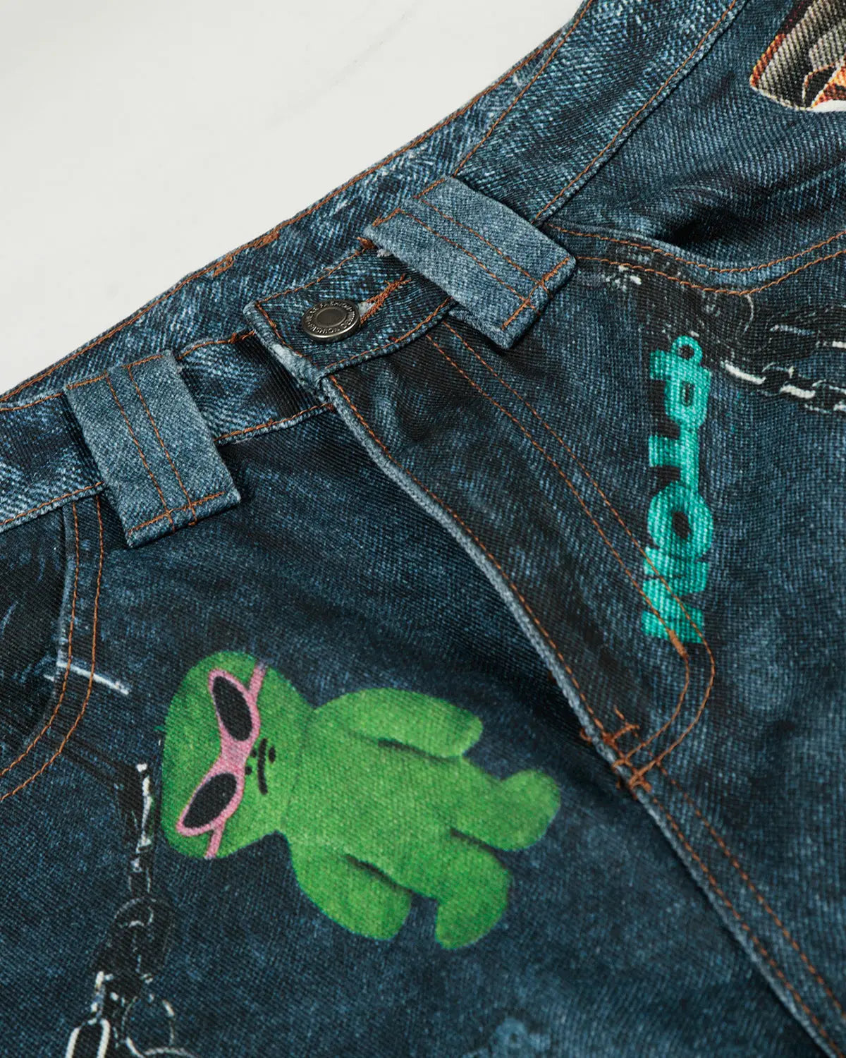Close-up of 3D print chain barrel jeans from INFLATION, showcasing detailed chain pattern and rugged denim texture.