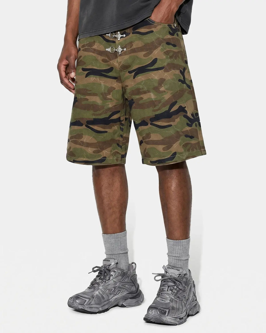 Inflation Metal Clasp Camo Shorts, stylish military-inspired pants with metal clasp closure, featuring camouflage pattern.