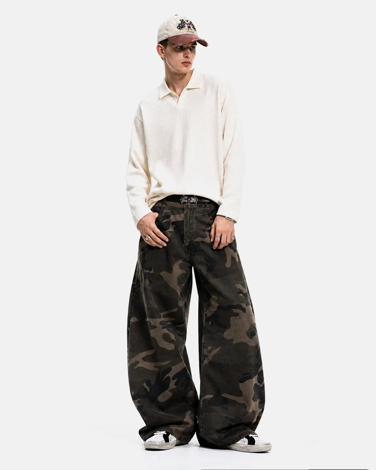 Inflation Streetwear studded camo barrel jeans, with metal studs and distressed details, featuring a relaxed fit and camouflage pattern.