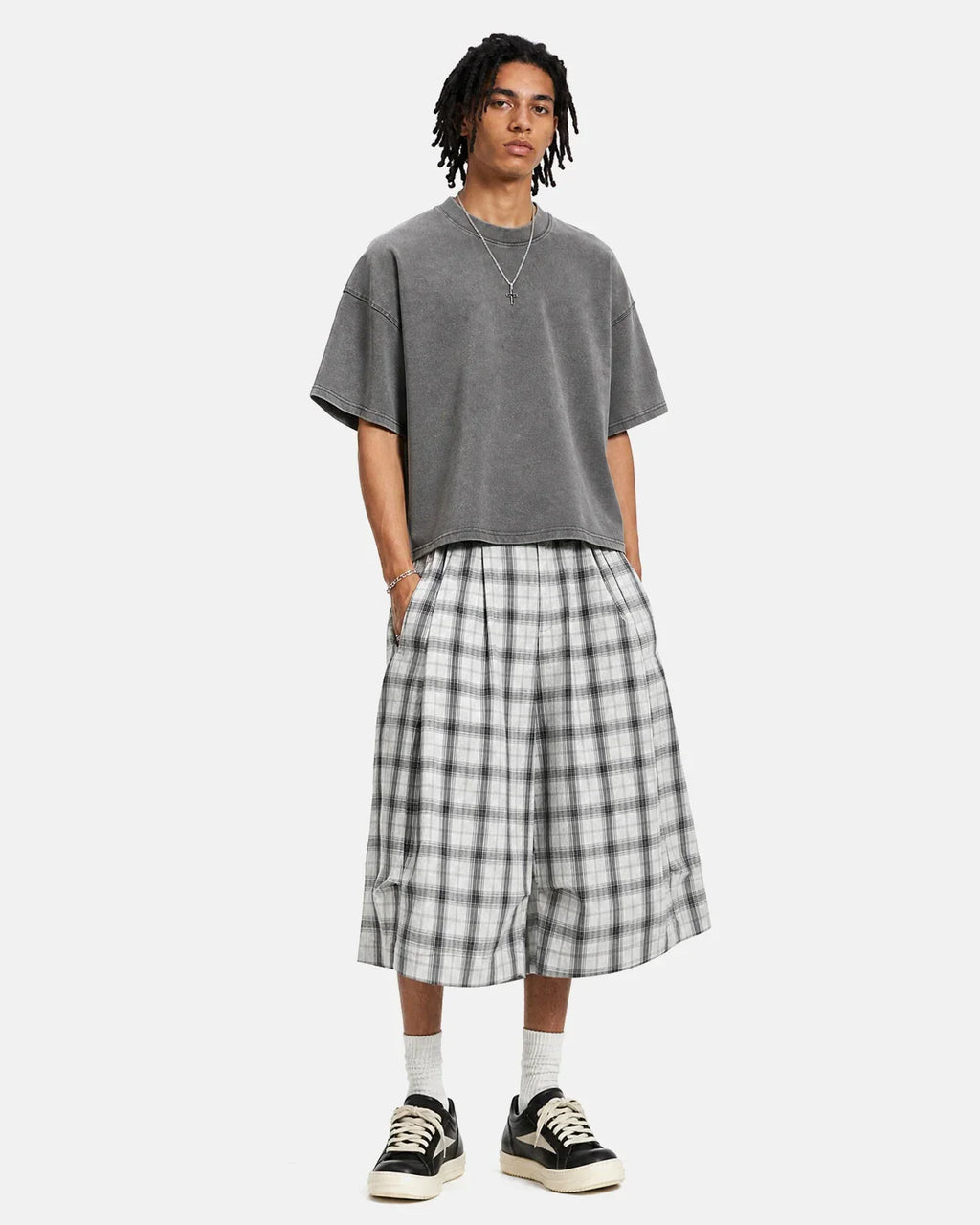 Inflation brand plaid longline casual shorts with a relaxed fit, featuring a stylish checkered pattern and side pockets.