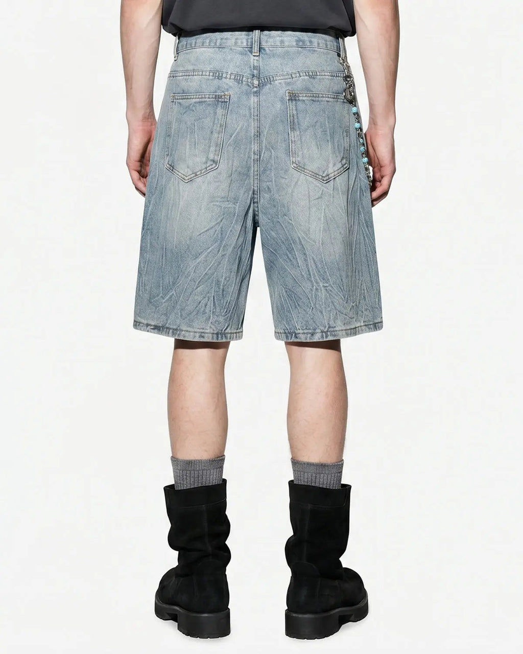 Textured washed longline jorts from INFLATION Streetwear, showing distressed denim fabric and relaxed fit pants style.